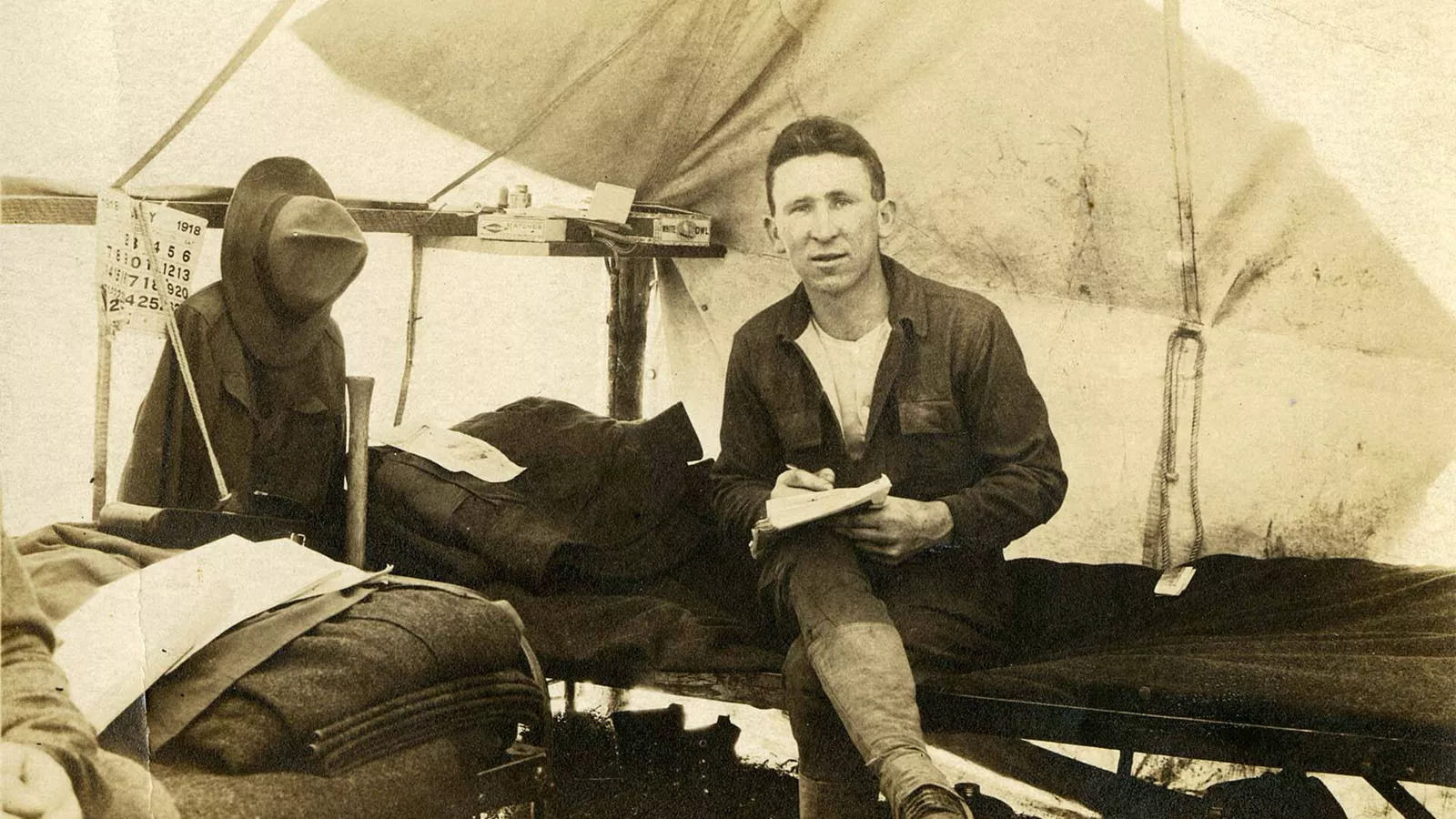 A cot in a canvas tent illustrates the raised sleeping position