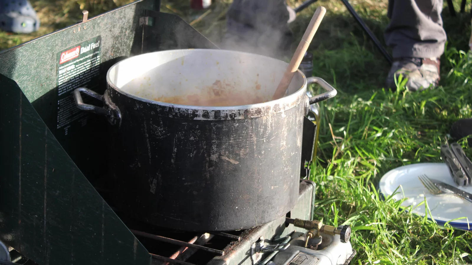 Two-burner liquid-fuel camping stove ready for outdoor cooking
