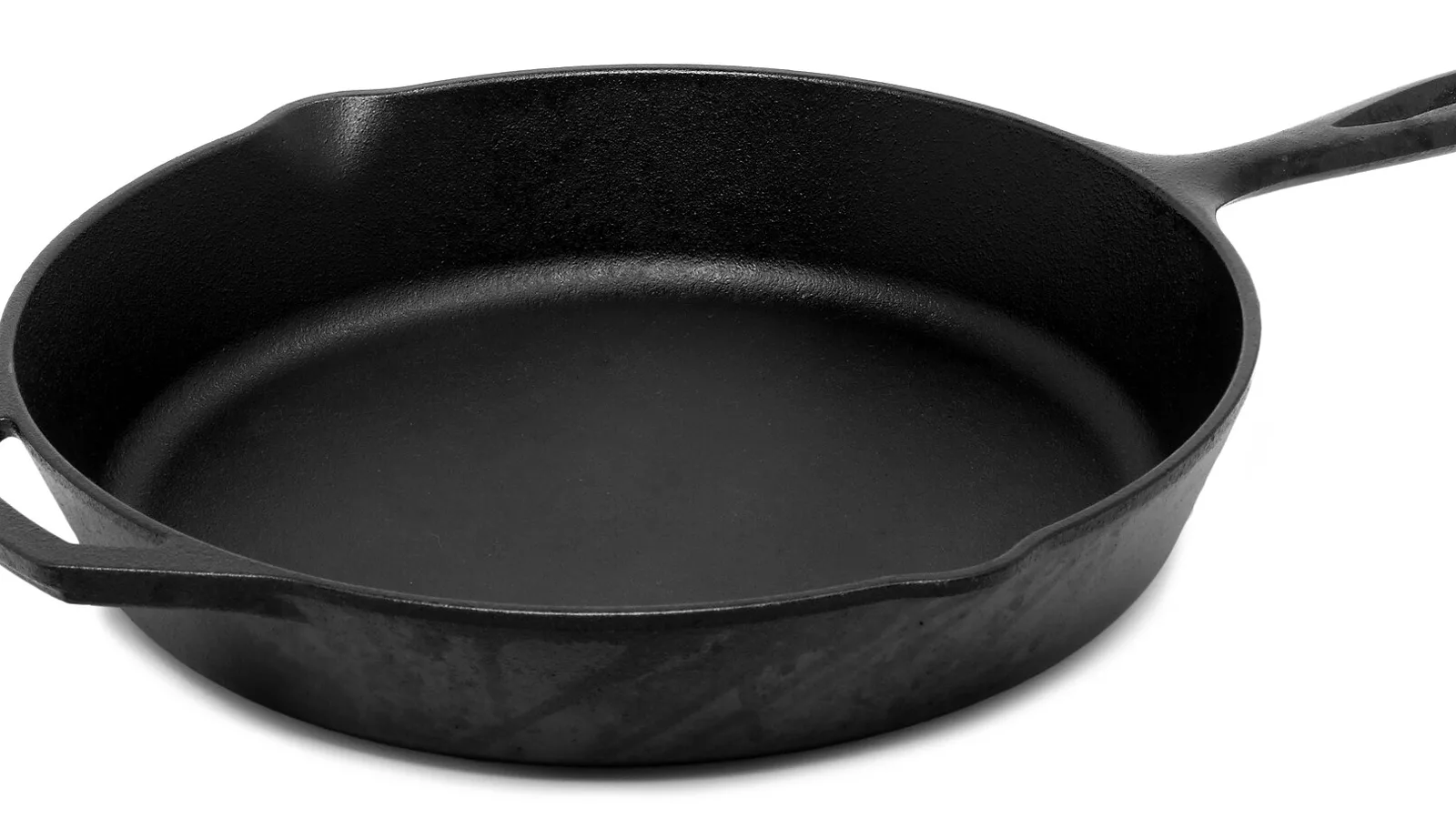 Traditional cast-iron skillet showing its thick cooking surface