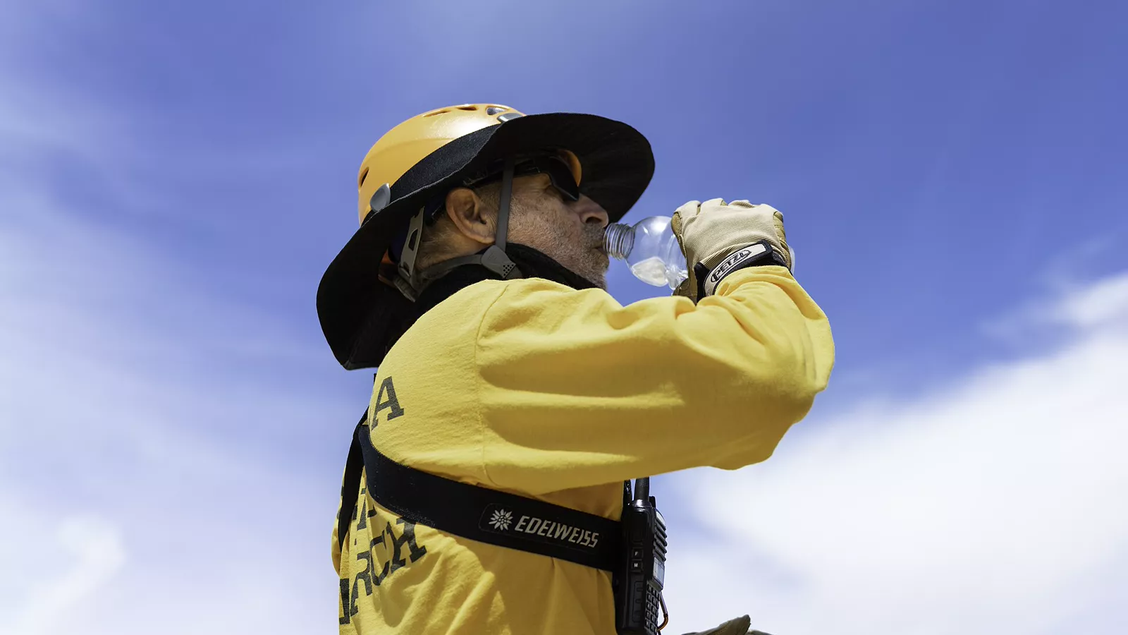 Search-and-rescue member drinking during summer heat