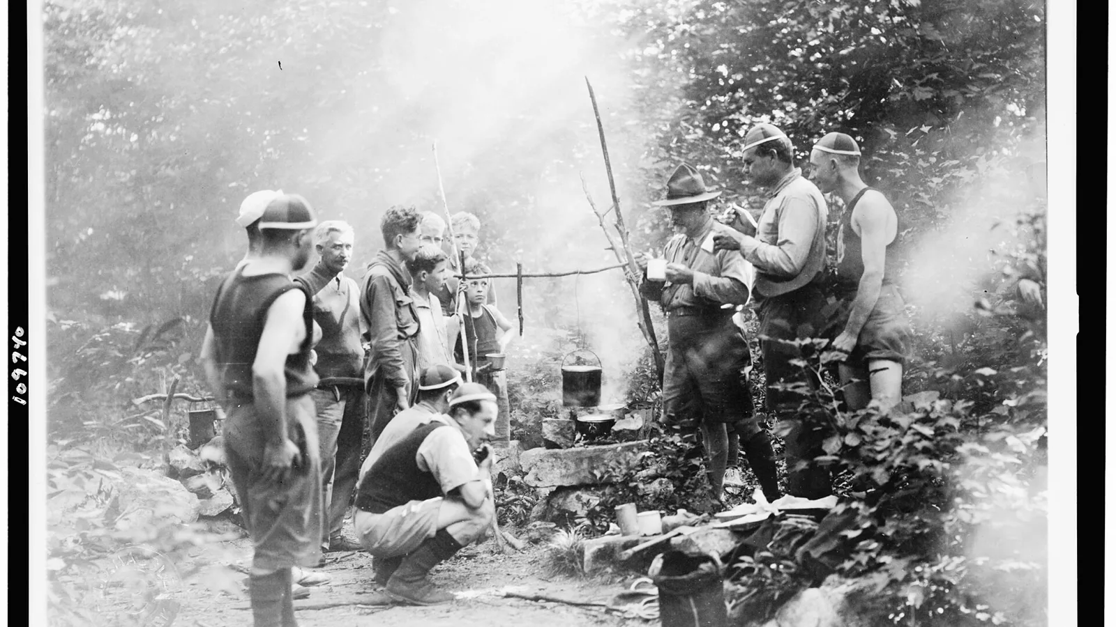Campers preparing food over a campfire