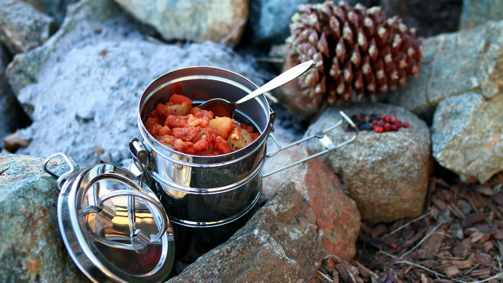 Camping meal in a metal container outdoors